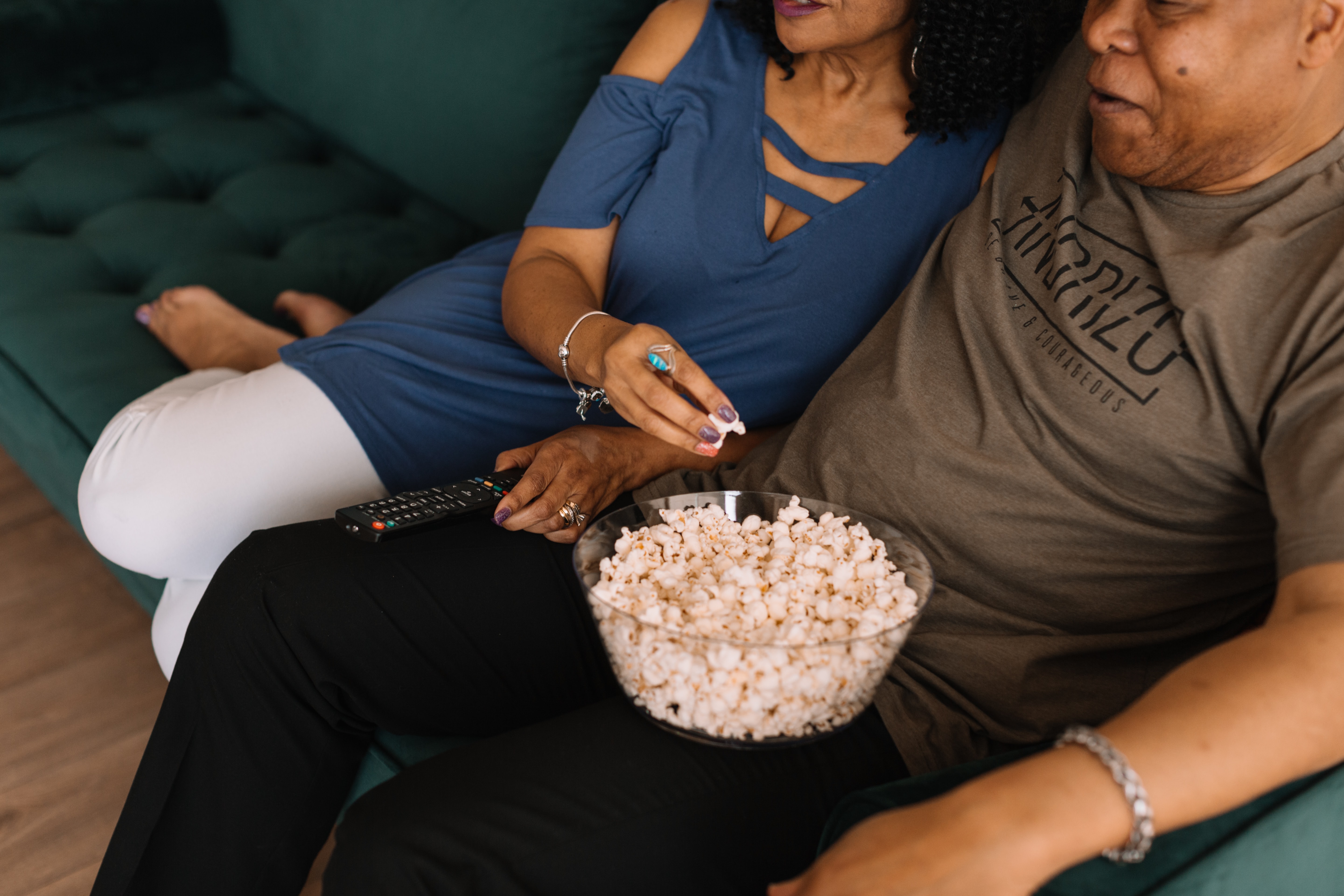 A couple eating popcorn.